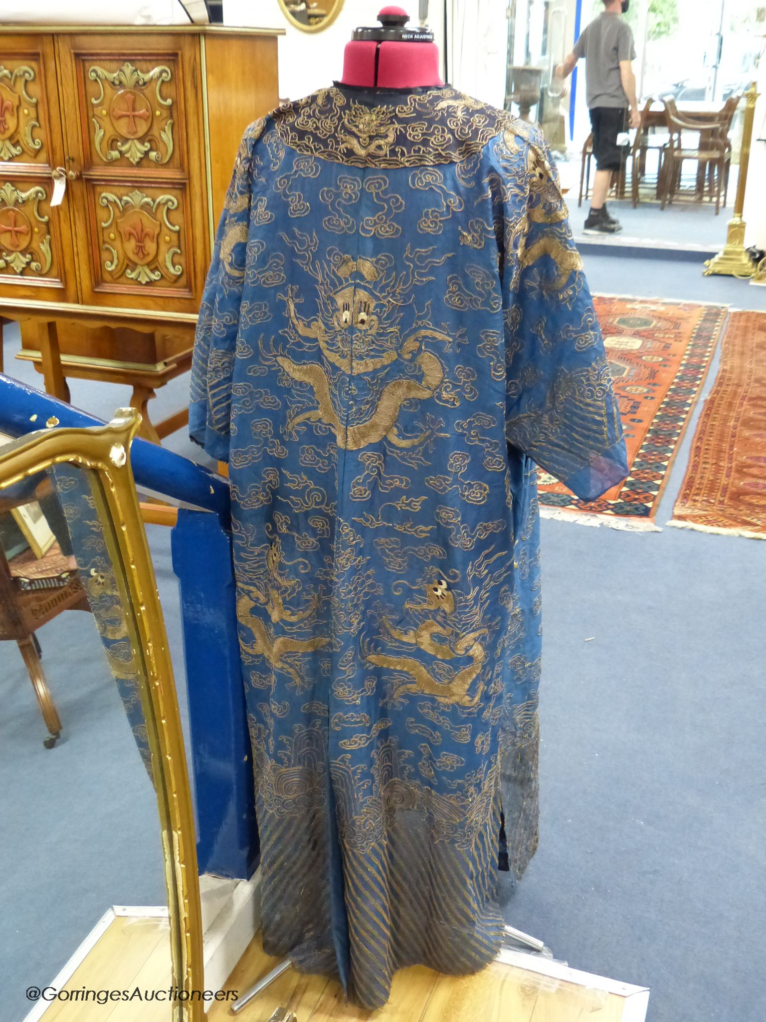 An early 20th century Chinese Summer robe, worked on fine gauze, with gold thread dragon embroidery